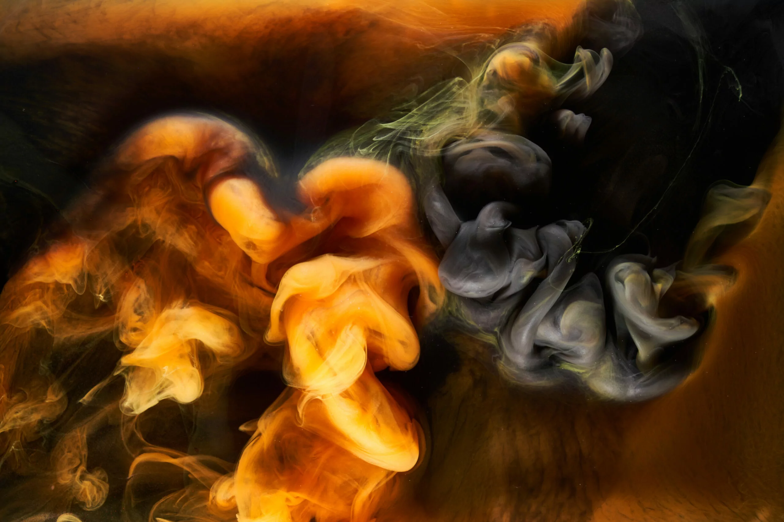 orange smoke on black ink background, colorful fog, abstract swirling ocean sea, acrylic paint pigment underwater