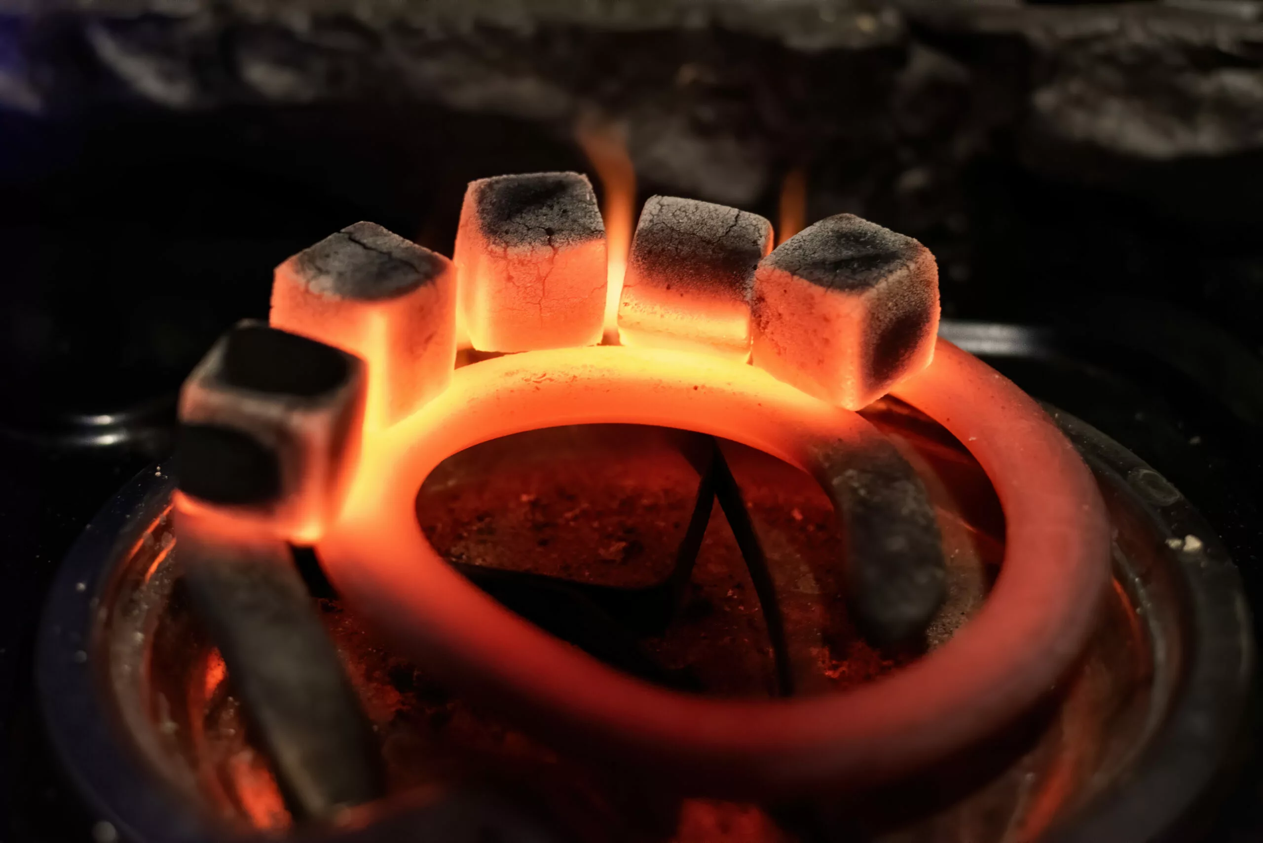 Five coals heating on a hookah stove