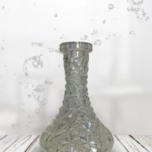 Glass vase with water splashes on white background.